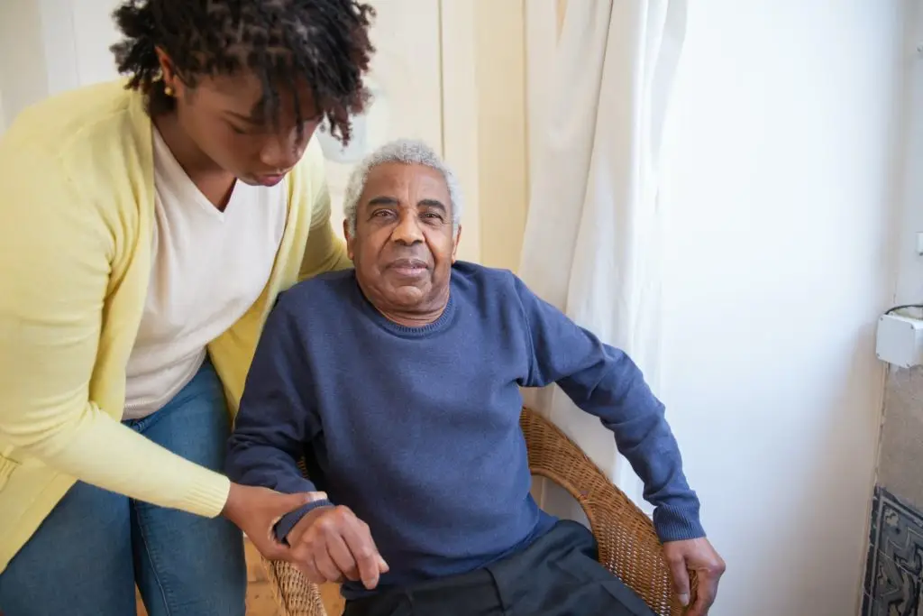 Elders' Helpers employee assisting senior man with in-home care services.